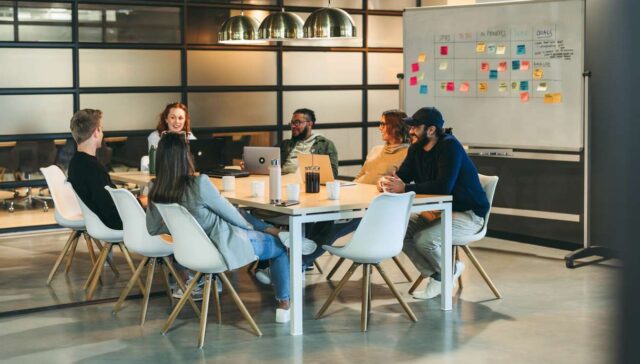 Team office meeting: Innovating solutions for software development in a tech company