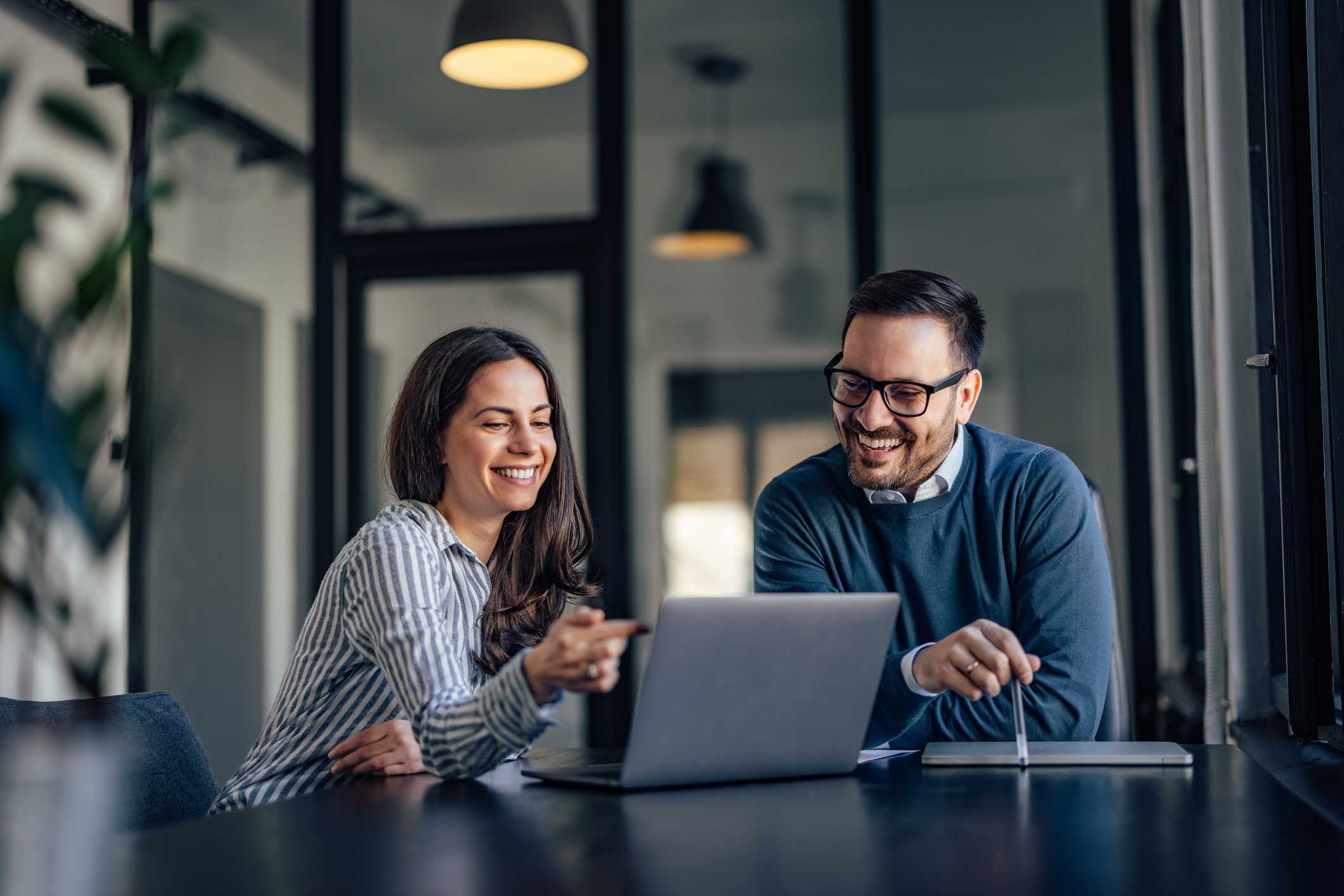 Smiling people, in the meeting room, using a laptop, searching