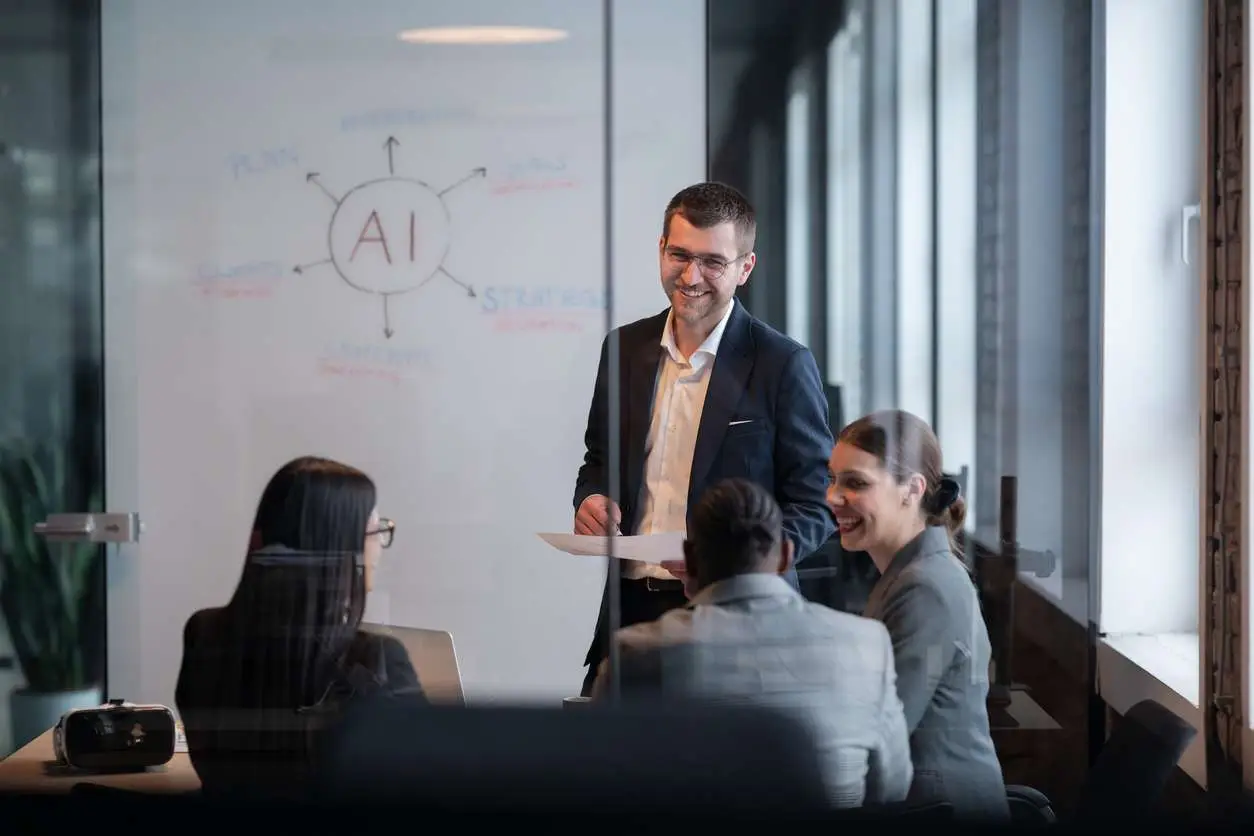 Diverse business team in a modern office during a meeting, discussing artificial intelligence strategy. Concept of AI innovation, teamwork, leadership, corporate planning, professional collaboration