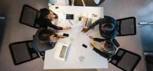 collague discuss on a table, photo taked from above