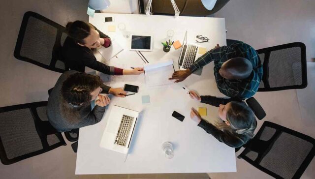 collague discuss on a table, photo taked from above