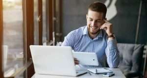 Men wathching something on tablet and laugh