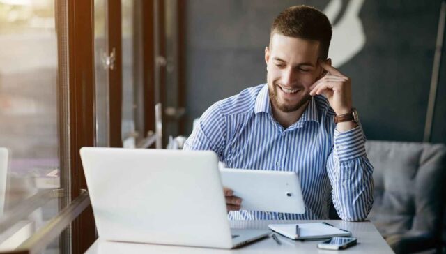 Men wathching something on tablet and laugh