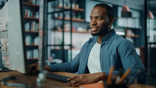 A black men seriously watching their computer system