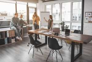 team members discussing in meeting space