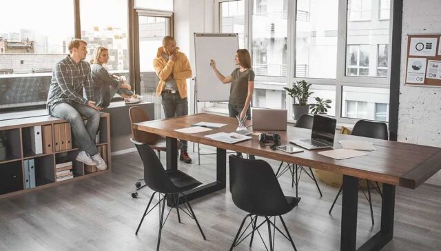 team members discussing in meeting space