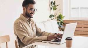 men typing something on laptop
