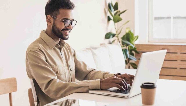 men typing something on laptop