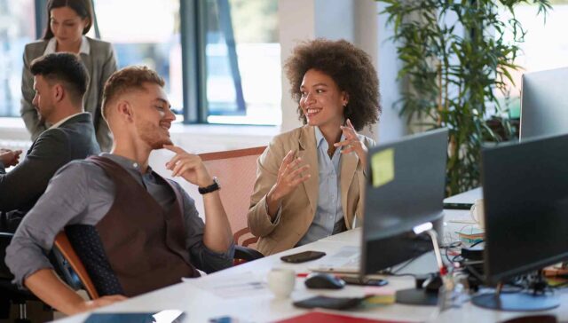 collague talking with each other with smile