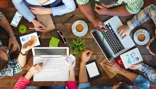 office colleague sitting together with their accessories on a table
