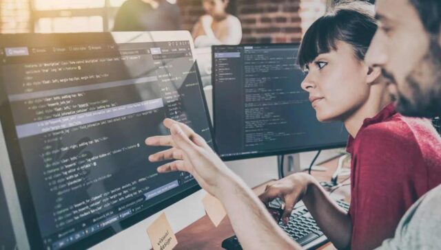 technical professionals watching codes in system