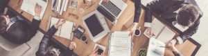 IT employees working on a office table with their accessories