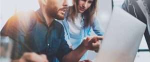 a men sharing some points with their women colleague in office