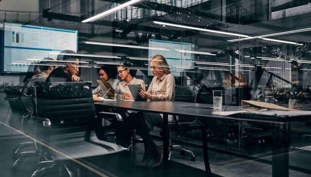 employees working in a glass covered office