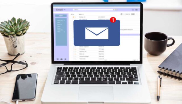 Email message inbox notification on laptop screen, business background