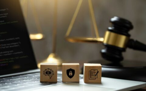 AI ethics and AI Law concept. wooden cube with AI icons on the laptop and a judicial gavel . artificial intelligence law and online technology of legal law regulations. AI technology group control .