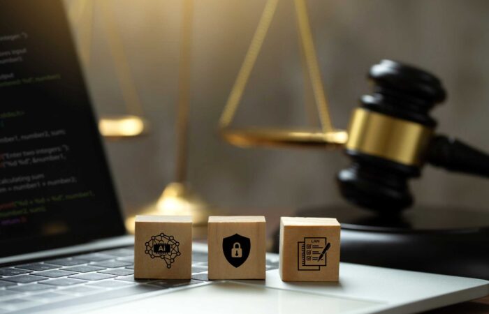 AI ethics and AI Law concept. wooden cube with AI icons on the laptop and a judicial gavel . artificial intelligence law and online technology of legal law regulations. AI technology group control .